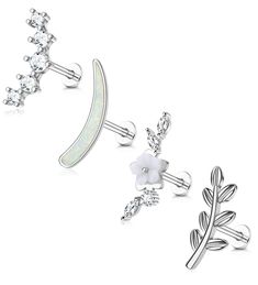 three different types of piercings with flowers and leaves on each earring, one in white