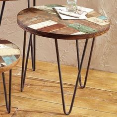 two wooden tables sitting on top of a hard wood floor next to eachother