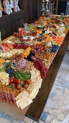 a long table covered with lots of different types of food on top of each other