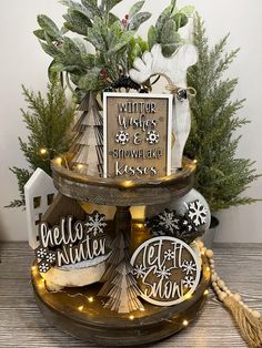 a three tiered tray with christmas decorations on it