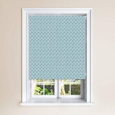 a window with a blue roman blind in front of it