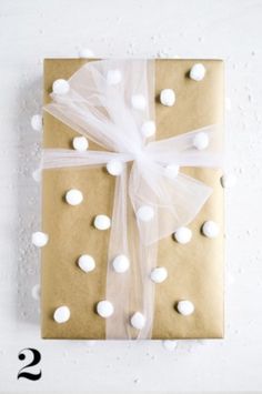 a present wrapped in brown paper with white polka dots