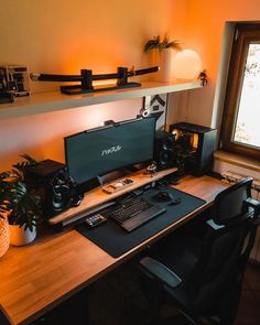 a desk with a computer, keyboard and mouse on it in front of a window