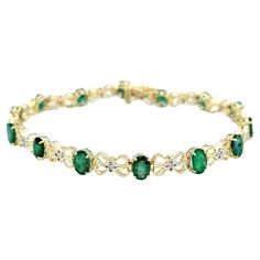 This elegant 14 karat gold tennis bracelet is a breathtaking testament to the timeless allure of emeralds and diamonds. The bracelet's design is a harmonious interplay of vibrant oval emeralds, each exuding a lush green hue, and infinity loop motifs that add a touch of continuity and sophistication. The brilliance of the emeralds is further accentuated by the captivating presence of white diamonds, nestled at the heart of each loop in a setting of contrasting white gold. Crafted with meticulous attention to detail, the bracelet not only showcases the rich color of the emeralds but also emphasizes the dazzling sparkle of the diamonds through the strategic use of white gold. The result is a piece that seamlessly marries classic gemstones with a contemporary design, creating a timeless access Elegant Green Oval Diamond Bracelet, Elegant Emerald Diamond Bracelet For Formal Occasions, Elegant Formal Emerald Diamond Bracelet, Elegant Diamond And Emerald Bracelet With 17 Jewels, Elegant Green Diamond Bracelet With Accents, Elegant Yellow Gold Emerald Tennis Bracelet, Elegant Yellow Gold Bracelet With Emerald, Elegant Emerald Tennis Bracelet For Formal Occasions, Elegant May Birthstone Tennis Bracelet For Formal Occasions