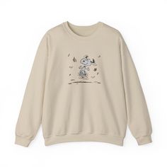 Stay cozy and stylish during the fall season with this peanuts snoopy fall autumn sweatshirt. Perfect for those chilly months, this sweatshirt offers a comfy fit with a classic crew neckline and double-needle stitching for durability. The medium-heavy fabric blend of 50% cotton and 50% polyester ensures warmth and comfort, while the ribbed knit collar retains its shape. Whether you're a peanuts fan or just love autumn vibes, this sweatshirt is a great addition to your wardrobe. Product features Charlie Brown Shirt, Snoopy Hoodie, Snoopy Fall, Snoopy Sweater, Hoodie Cozy, Brown Shirt, Halloween Stuff, Autumn Vibes, Peanuts Snoopy