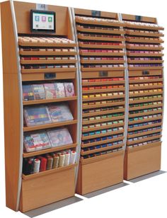 two wooden bookshelves with magazines on each shelf and an electronic clock above them