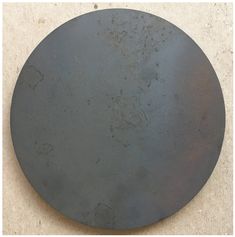 a round metal object sitting on top of a floor