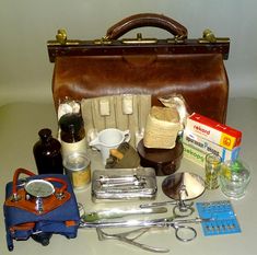 You are viewing a Vintage Old First Aid Doctor's Bag with Medical Equipment Inside. Vintage Doctor's Bag made of Synthetic Leather. Inside Bag have vintage medical doctor's pieces: -  two different size medical bottles in color glasses and one piece white medical jug; -  small cup glass, small blood cupping glass, and Bakelite box; -  medical package and four pieces a big size needles in original package; -  set of metal medical and doctor's instruments and tools in used condition: metal tongue Vintage Medical Equipment, Tongue Depressor, Color Glasses, Medical Bag, Medical Kit, Vintage Medical, Doctor Bag, Inside Bag, Medical Equipment