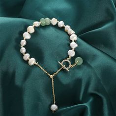 Crafted with high-quality genuine freshwater pearls and accented with aventurine gemstones, this bracelet is a true statement piece. Each pearl is hand-selected for its radiant luster and is 100% unique, while the aventurine gemstones add a touch of natural beauty to this exquisite piece. Whether you're dressing up for a special occasion or adding a touch of sophistication to your everyday look, our pearl bracelet is the perfect accessory for any occasion. Genuine natural freshwater pearls Accen Jade Pearl Bracelet With Natural Stones Gift, Elegant Jade Pearl Bracelet For Gift, Elegant Aventurine Bracelet Jewelry, Elegant Aventurine Bracelet, Elegant Green Pearl Bracelet With Natural Stones, Elegant Green Crystal Bracelet With Natural Stones, Elegant Green Jade Pearl Bracelet, Elegant Green Jade Bracelet, Elegant Green Pearl Bracelet