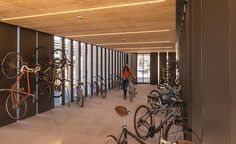 a man walking down a hallway filled with lots of bikes