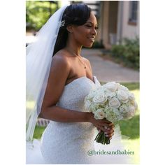 a woman in a wedding dress holding a bouquet