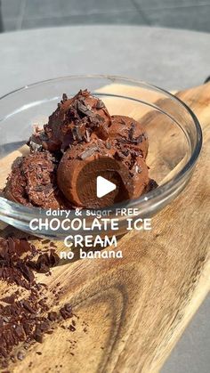 a bowl filled with chocolate ice cream on top of a wooden table