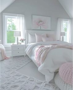 a bedroom with white furniture and pink accents