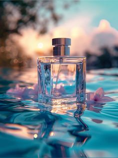 a bottle of perfume sitting on top of a body of water