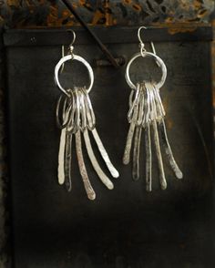 'Gatekeeper' are long sterling silver fringe dangle earrings that have been entirely hand sculpted and hand textured for an edgy look full of movement and drama. Part of my Silence and Noise series exploring texture and movement within design, this piece is an easy and fun piece to wear. Edgy enough to make a statement, yet sophisticated enough to wear with a cocktail gown....just the sort of piece to go everywhere with you and become your go-to go-anywhere dress them up and dress them down sort Sterling Silver Long Drop Dangling Charms Jewelry, Unique Long Drop Chandelier Earrings, Silver Jewelry With Dangling Long Drop Charms, Modern Sterling Silver Earrings With Dangling Charms, Silver Long Drop Earrings With Dangling Charms, Earrings Edgy, My Silence, Cocktail Gowns, Long Fringe