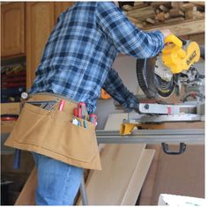 a man using a circular saw to cut wood