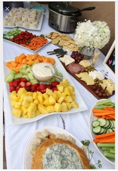 a table full of different types of fruits and vegetables on plates next to an app