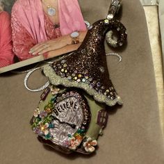 an ornament is sitting on top of a table next to a woman's book