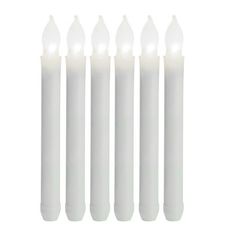 six white candles with one lit on each side