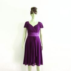 a mannequin dressed in a purple dress