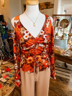 A stunning top for any occasion, the Fall Floral Satin Tie Top is sure to make a statement. Featuring a vibrant pattern, luxurious colors, and lined, you'll love the flattering fit and front tie that adjust the length. Plus, the slight cutouts at the shoulders and back zipper add polished elegance! Add a touch of flair to your look with jeans or the matching skirt. Fit is true to size. Emily is 5'8" wearing a medium. XS (0-2) Small (2-4) Medium (6-8) Large (10-12) Luxurious Colors, Stunning Tops, Tie Top, Fall Floral, The Fall, Satin, Boutique, Zipper, Skirt