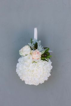 a bouquet of white flowers and greenery on a gray background with the words b + b above it