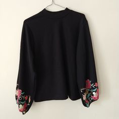 Zara Long Sleeved Top Bell Sleeves With Elastic Cuff Bright, Colorful Floral Design On Bottom Of Sleeves Mock Neck Lightly Textured Fabric Loose Fit Polyester, Spandex New Condition, Never Worn Pretty, Unique, And Versatile! Zara Black Embroidered Tops, Zara Black Tops With Floral Embroidery, Black Long Sleeve Top With Embroidered Sleeves, Black Tops With Embroidered Sleeves For Fall, Black Long Sleeve Blouse With Embroidered Sleeves, Fitted Black Top With Embroidered Sleeves, Trendy Black Tops With Floral Embroidery, Black Cotton Tops With Embroidered Sleeves, Chic Long Sleeve Tops With Embroidered Cuffs