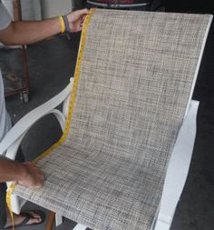 a man working on a piece of furniture with a measuring tape in his right hand