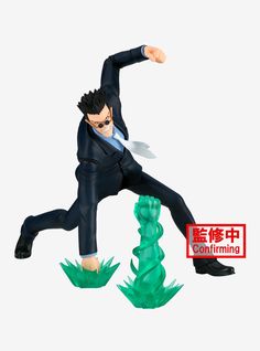 a figurine of a man in a suit and tie is posed on top of a green object