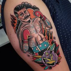 a man with a tattoo on his arm holding a boxing glove