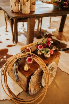 the table is set up with vases and baskets on it, along with other items