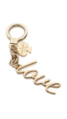 a gold key chain with the word love and two hearts hanging from it's side