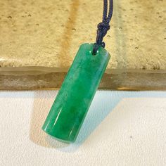 The dainty intenese green rectangular jade pendant is a beautiful piece that can easily match your daily outfit. It is a minimalistic necklace and has unique color tone.  This is the perfect gift for family and friend. It suits well to men or women for any outfit. It is a special gift for mother's day, valentine's day, wedding, anniversary, birthday, Christmas, Easter, New Year's and any holiday.  Material: Natural Untreated Jadeite, Genuine Type A Jadeite Product A size Height 51.0 mm Width 13.0 mm Thickness 5.0mm Product B size Height 32.0 mm Width 10.0 mm Thickness 4.0mm Product C size Height 53.0 mm Width 11.0 mm Thickness 8.0mm The processing time is 3-5 business days. Everything is handcrafted with exceptional care in Hong Kong. Item is wrapped in beautiful box! Note: Color differenc Green Rectangular Spiritual Jewelry, Spiritual Green Rectangular Jewelry, Rectangular Green Jade Jewelry, Green Rectangular Jade Jewelry, Minimalistic Necklace, Burmese Jade, Color Tone, Jade Pendant, Green Jade