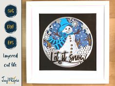 a paper cut snowman with the words let it snow in black, white and blue