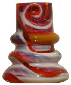 a colorful glass vase sitting on top of a white table