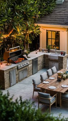 an outdoor kitchen and dining area is lit up at night