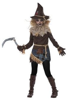 a woman dressed as a scarecrow holding a large ax in her right hand and wearing a brown hat