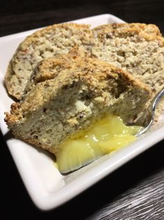 a close up of a piece of bread on a plate with butter and syrup in it