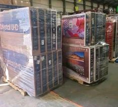 there are many boxes stacked on top of each other in the warehouse with pallets