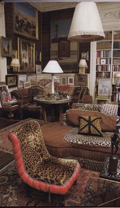 a living room filled with lots of furniture and bookshelves covered in animal print