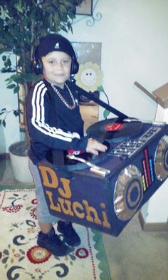 a young boy sitting in front of a boombox