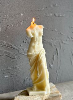 a candle that is sitting on top of a piece of wood