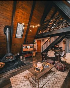 a living room filled with furniture and a fire place in the middle of a loft