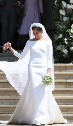 the bride and groom are walking down the steps