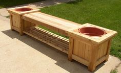 two wooden planters sitting next to each other on top of a cement slab in the grass