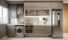 a modern kitchen with stainless steel appliances and cabinets