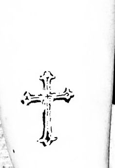 a cross on the side of a white cup