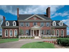 a large red brick house with white trim