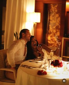 a man and woman sitting at a dinner table