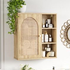 a wooden cabinet with some bottles and soaps in it next to a mirror on the wall